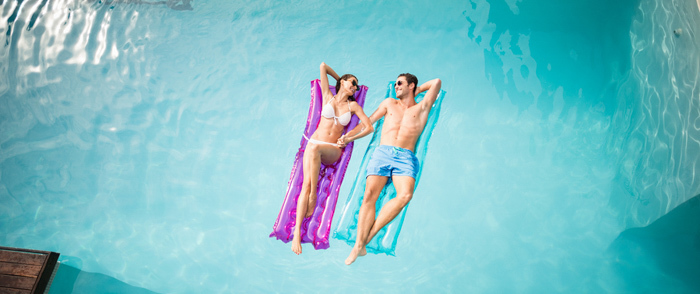 A couple floating in a swimming pool