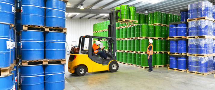 Forklift and driver in chemical barrel warehouse