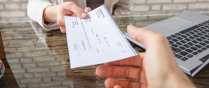 Payroll Protection Seven Tips to Source Secure Providers A check is handed to an employee