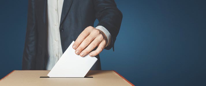 male voter putting ballot in box male voter putting ballot in box