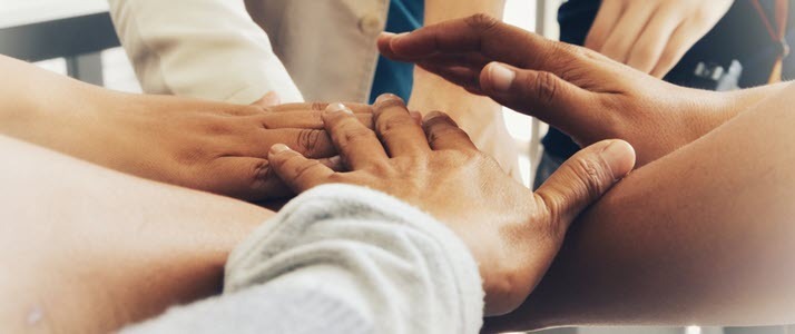 hands together in a huddle hands together in a huddle