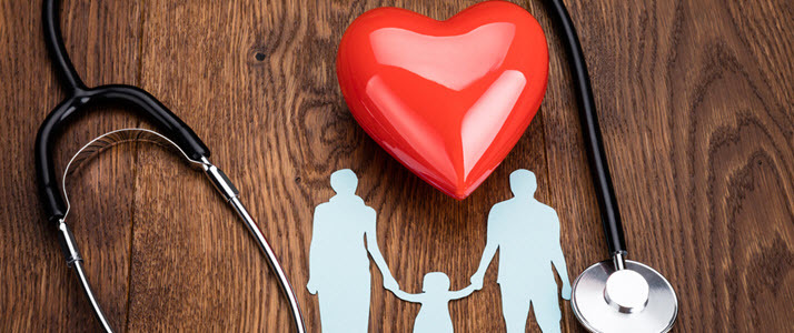 A photo illustration shows a cutout of a family near a heart and stethoscope