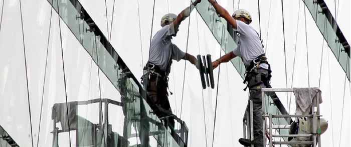 California OSHA Regulations A window washer is busy at work.