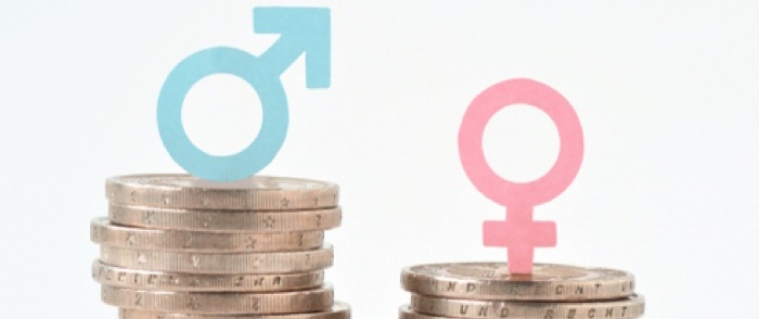 Unequal stacks of money illustrate the wage gap between men and women.