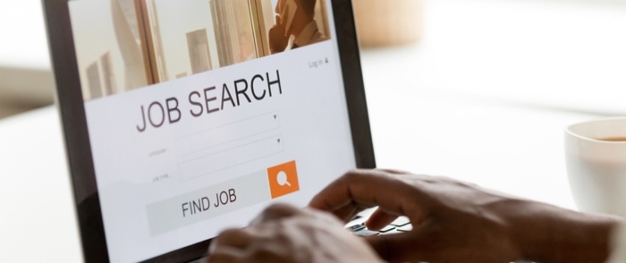 Supply and On Demand New Freelance Recruitment Strategies A man uses a laptop to search for jobs