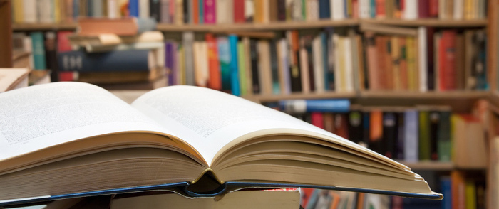 Closing the Skill Gap An open book sits on a desk in a library.