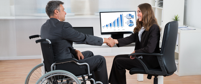 An employee in a wheelchair arrives for a job interview.