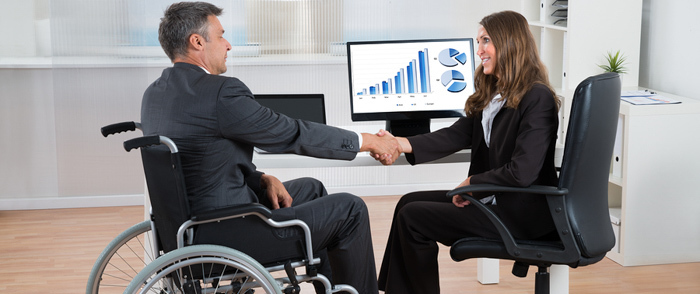 The Tax Incentives for Hiring Employees With Disabilities An employee in a wheelchair arrives for a job interview.