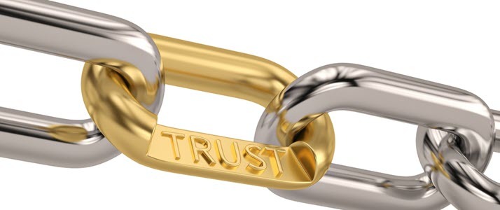 A chain with a golden link that reads trust