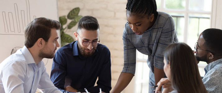 How to approach learning and development Leader teaches her team in office setting