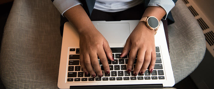 Aerial view of womans hands on laptop keyboard Aerial view of womans hands on laptop keyboard
