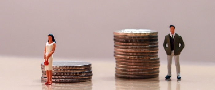 Workplace discrimination in the EU A man and a woman stand next to stacks of quarters The mans stack is taller