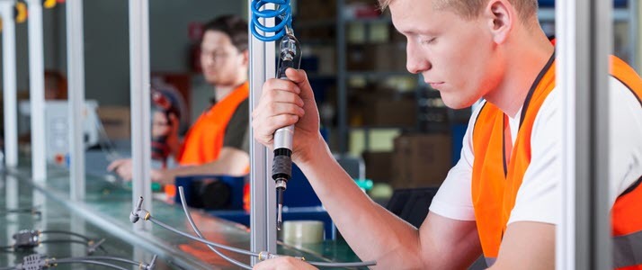 Time Tracking Young men work on an assembly line