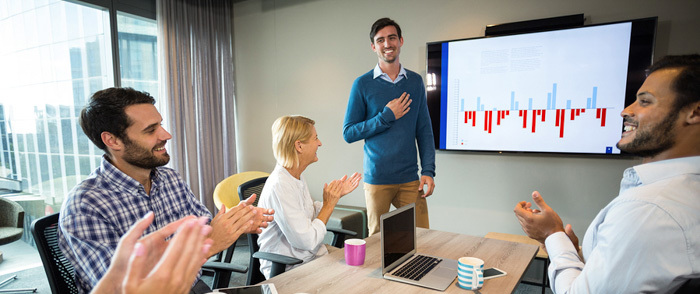 A man gives a presentation in an office.