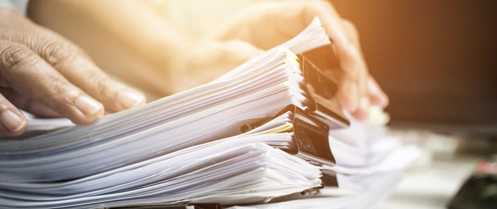 stacks of reports on desk stacks of reports on desk