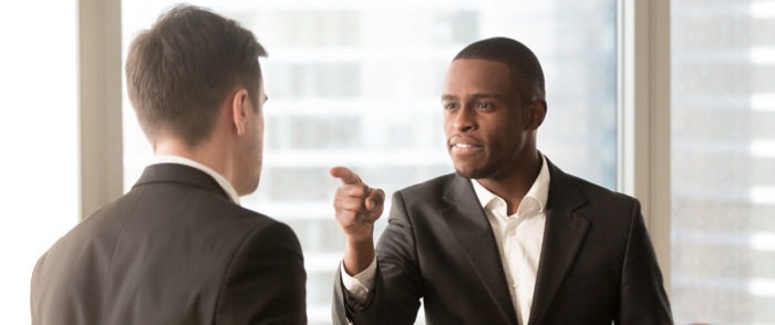 Workplace Bullying A business person bullies a colleague.