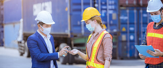 masked male and female workers on construction site masked male and female workers on construction site