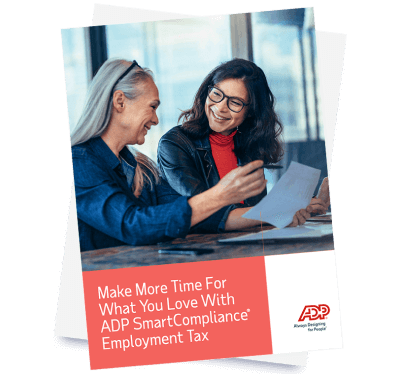 Two payroll professionals review the ADP Payroll Tax Compliance Guide together