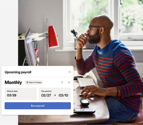  Small business owner at desk reviewing RUN for ONE upcoming payroll on laptop