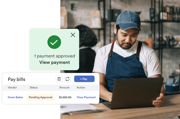 Man using laptop reviews bill payment dashboard with approved payment notification