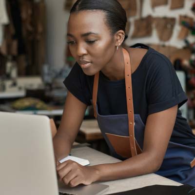 Woman looking and working on her laptop