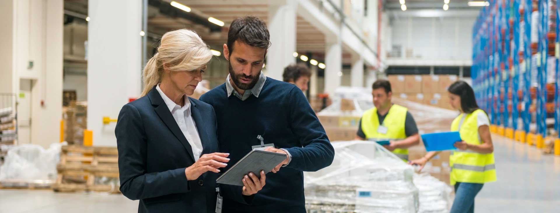 Multiple workers shown processing orders in an Amazon warehouse.