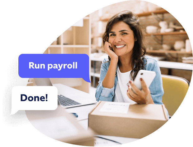 A woman holding phone running payroll with Roll by ADP