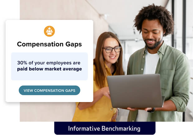Inset of sample compensation gap message set over image of two employees looking at a laptop